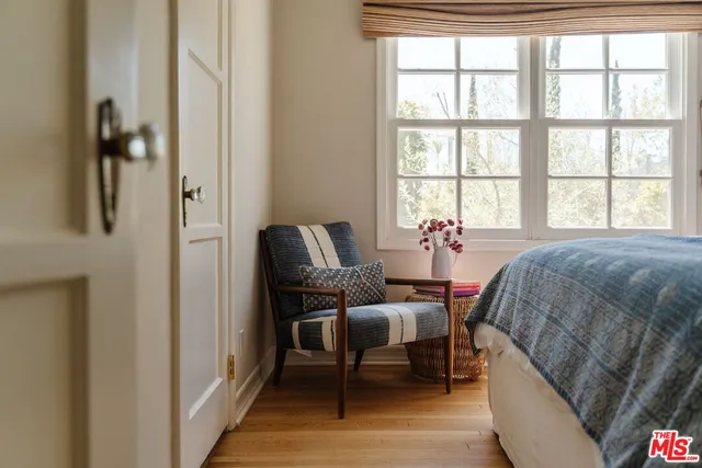 a living room with a bed furniture and a window