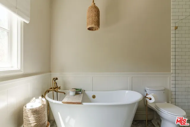 a bathroom with a granite countertop sink a mirror and shower