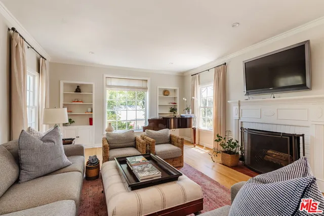 a living room with furniture fireplace and flat screen tv