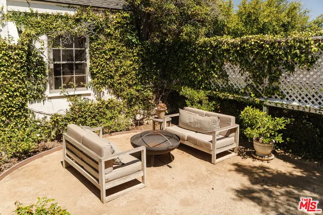 a view of a patio with table and chairs and potted plants