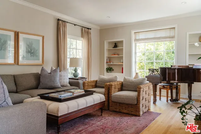 a living room with furniture and floor to ceiling windows