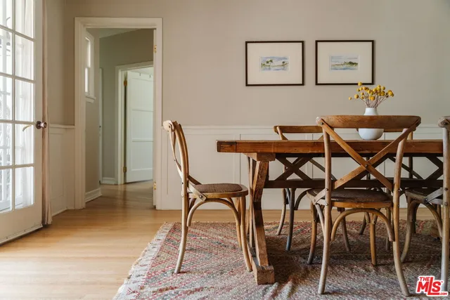 a view of a dining room with furniture and a potted plant