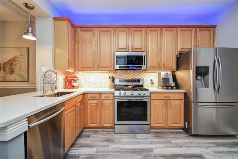 a kitchen with a refrigerator stove and sink