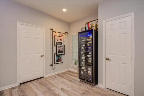 an empty room with window and wooden floor