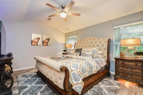 a bed sitting in a bedroom next to a window