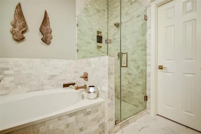 a bathroom with a bathtub and a shower