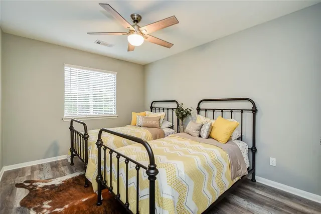 a bedroom with two beds and a chandelier