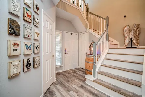 a view of a hallway with seating and lots of frames on wall