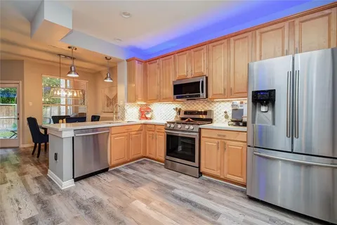 a kitchen with a refrigerator stove and sink