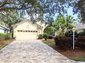 a pathway of a house with a yard and trees