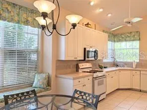 a kitchen with a sink cabinets and window