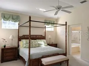 a bedroom with a bed and a mirror