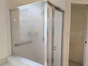 a bathroom with a glass shower door