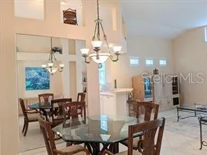 a view of a dining room with furniture and chandelier