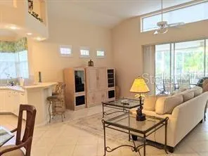 a living room with furniture a dining table and a lamp