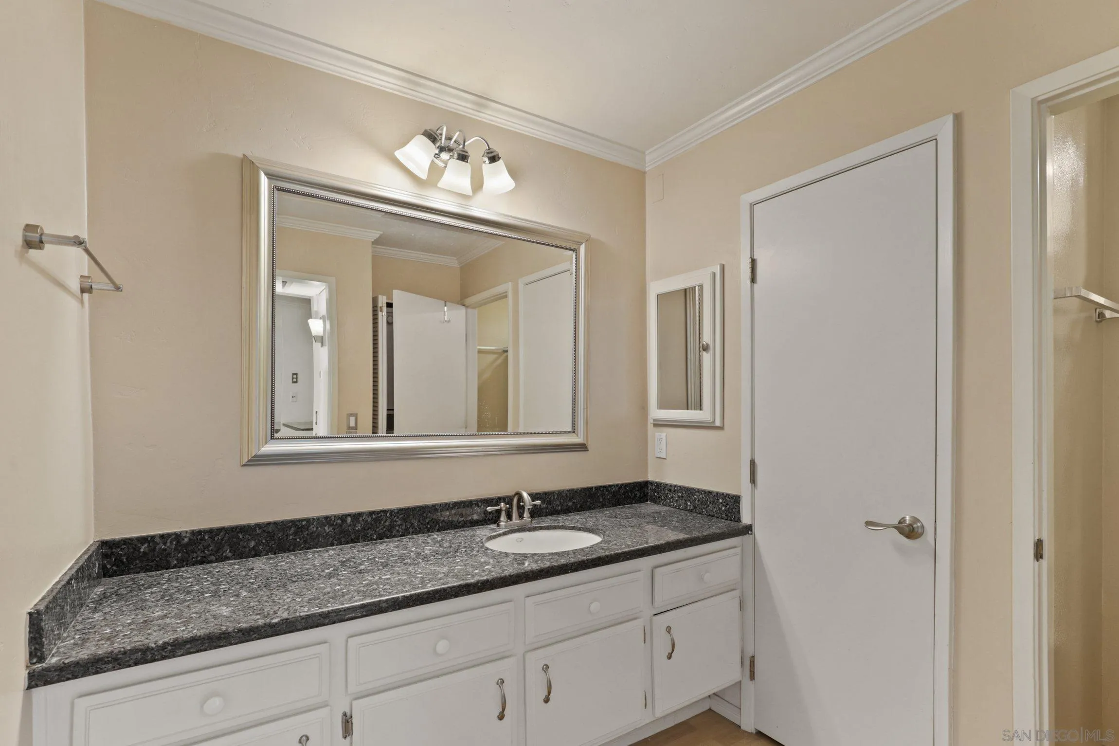 6757 Friars Road, Unit 13 San Diego, CA 92108 - Photo 11 of 15 a bathroom with a granite countertop sink and a mirror