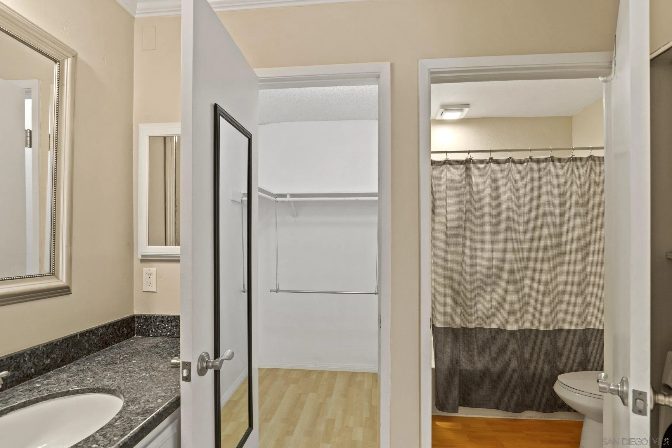 6757 Friars Road, Unit 13 San Diego, CA 92108 - Photo 12 of 15 a bathroom with a granite countertop shower and a sink