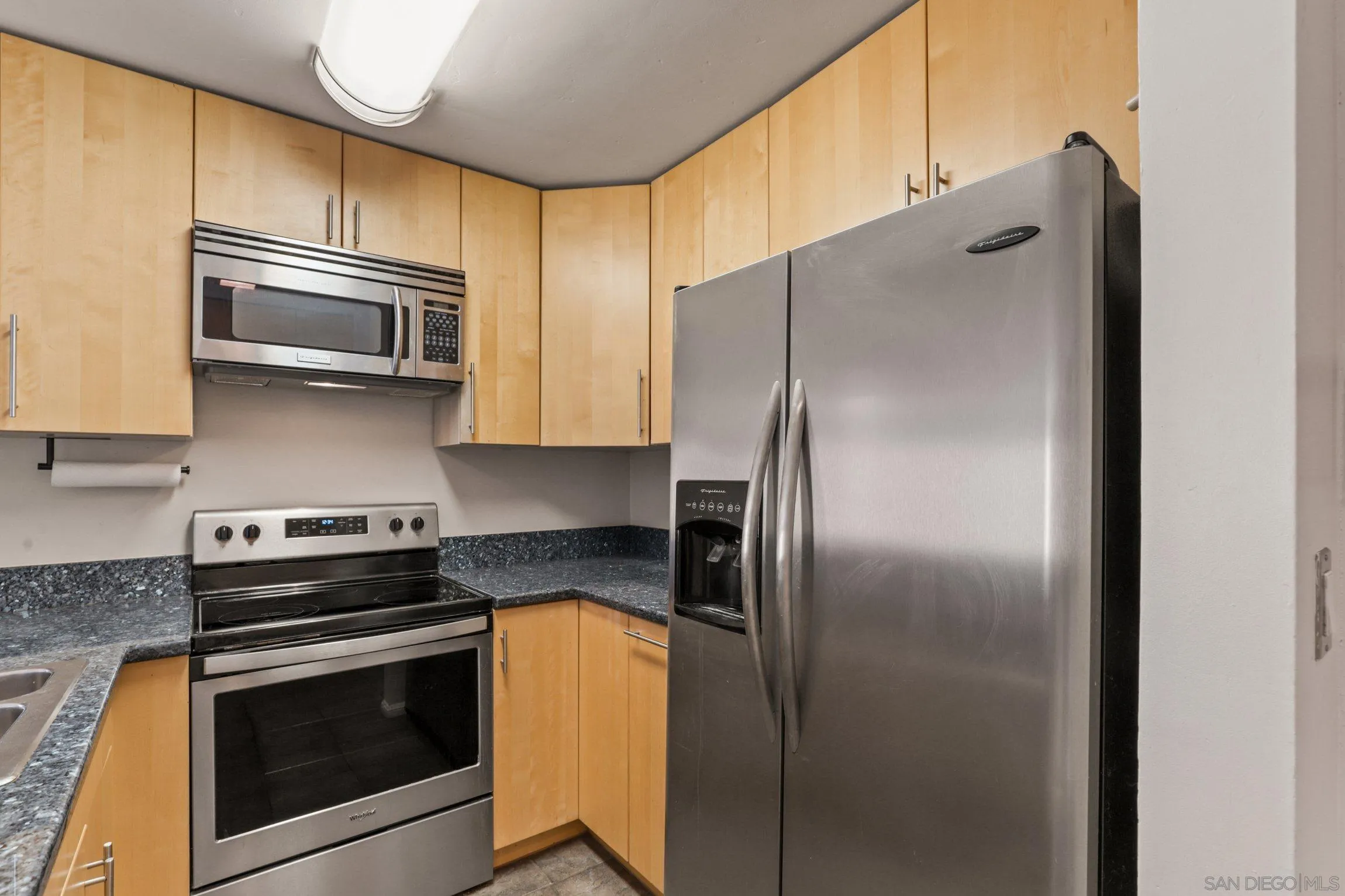 6757 Friars Road, Unit 13 San Diego, CA 92108 - Photo 7 of 15 a kitchen with stainless steel appliances granite countertop a refrigerator and a stove