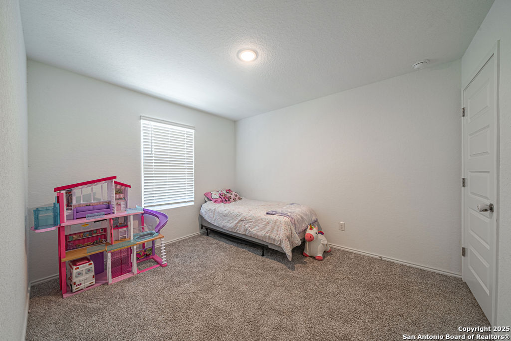 4422 Chandler Road, Unit 20 San Antonio, TX 78222 - Photo 21 of 38 a bedroom with furniture and a book shelf