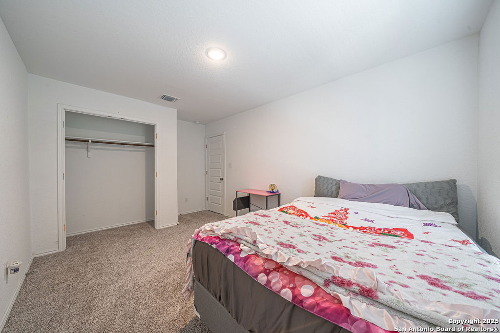 4422 Chandler Road, Unit 20 San Antonio, TX 78222 - Photo 22 of 38 a bedroom with a bed and a cabinets