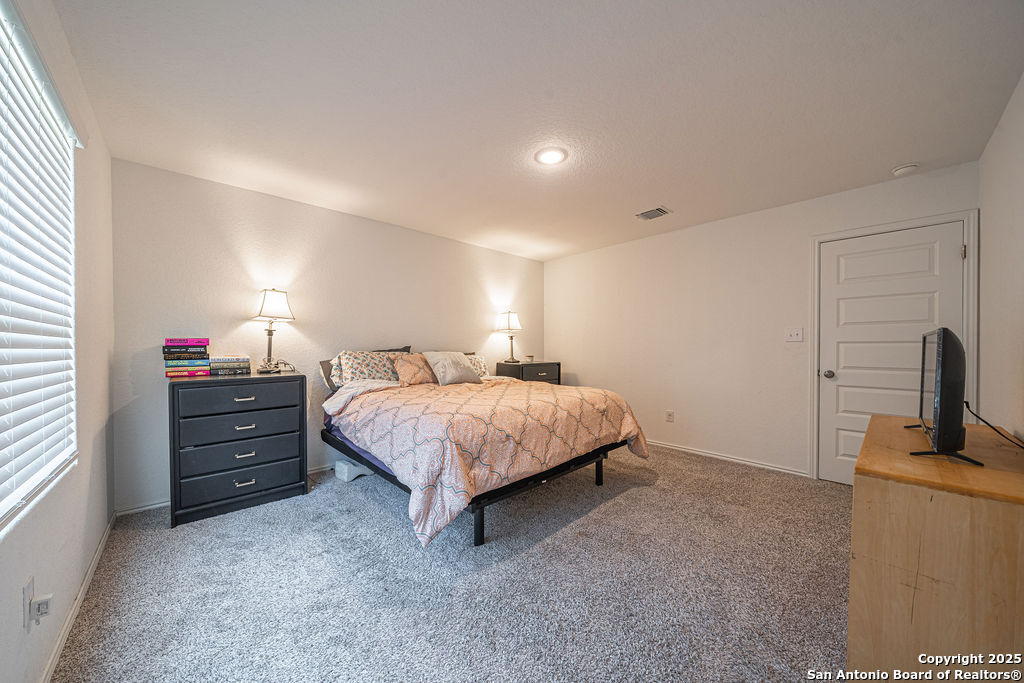 4422 Chandler Road, Unit 20 San Antonio, TX 78222 - Photo 24 of 38 a spacious bedroom with a bed and a flat screen tv