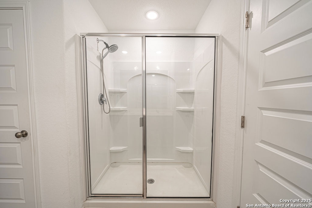 4422 Chandler Road, Unit 20 San Antonio, TX 78222 - Photo 27 of 38 a bathroom with a glass shower door