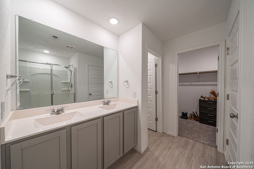 4422 Chandler Road, Unit 20 San Antonio, TX 78222 - Photo 29 of 38 a bathroom with a double vanity sink mirror and shower