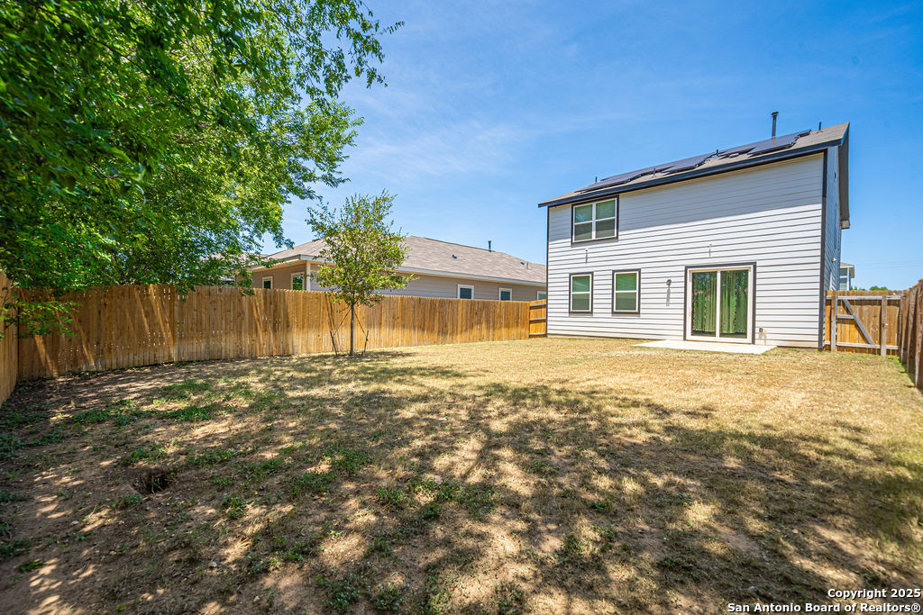 4422 Chandler Road, Unit 20 San Antonio, TX 78222 - Photo 32 of 38 a view of a house with a large tree and wooden fence