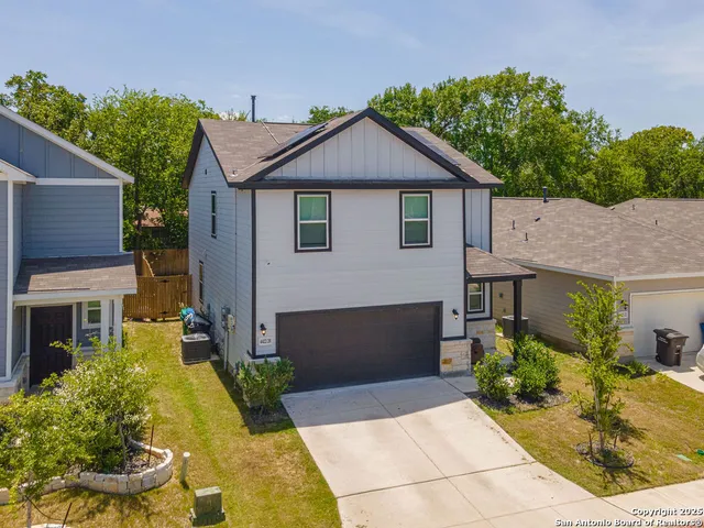 an aerial view of a house with a swimming pool