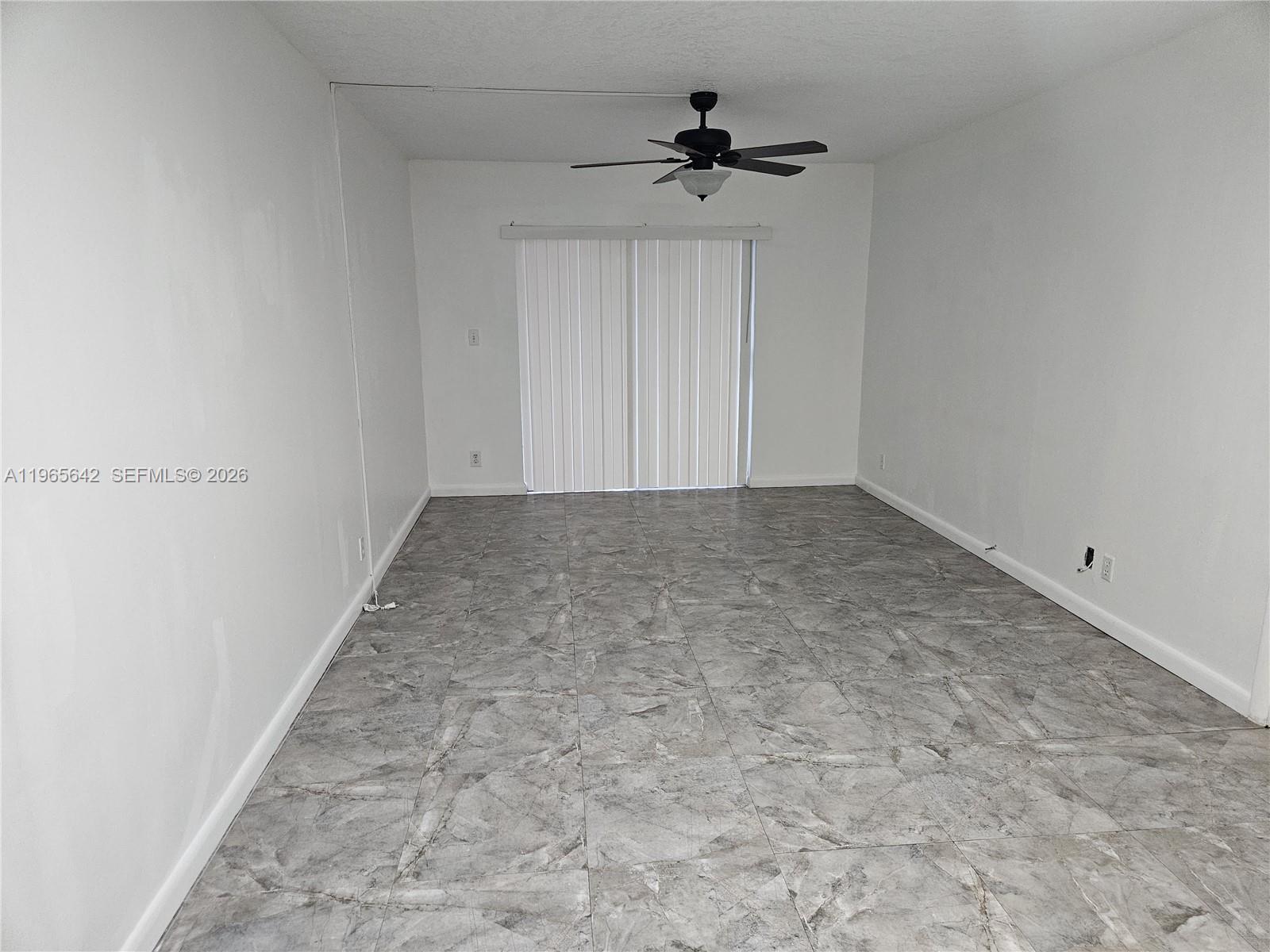 7610 Stirling Road, Unit 102C Davie, FL 33024 - Photo 3 of 11 a view of room with a ceiling fan