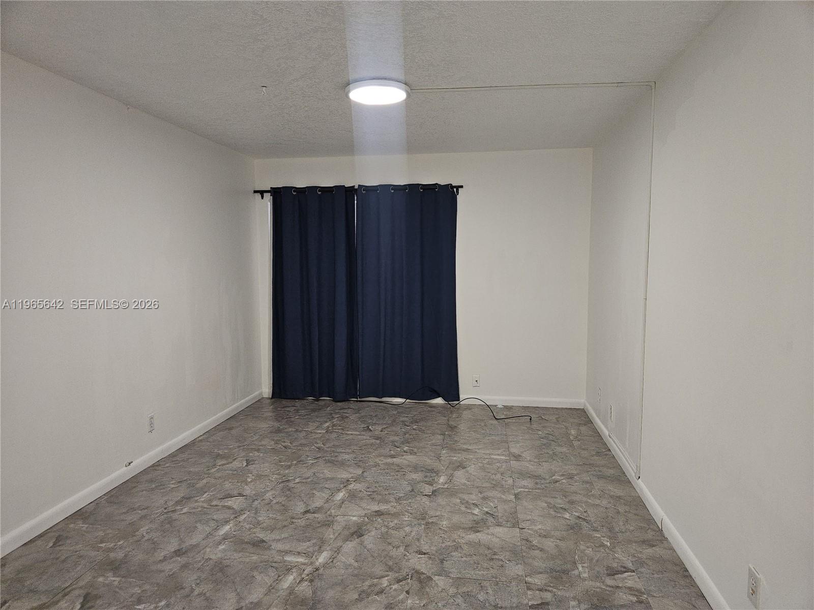 7610 Stirling Road, Unit 102C Davie, FL 33024 - Photo 6 of 11 wooden floor in an empty room
