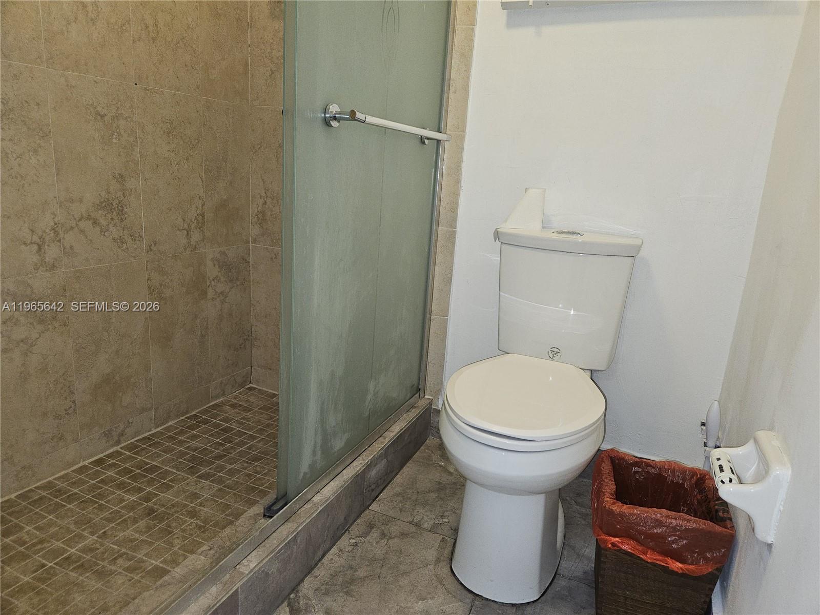 7610 Stirling Road, Unit 102C Davie, FL 33024 - Photo 8 of 11 a bathroom with a toilet and a sink