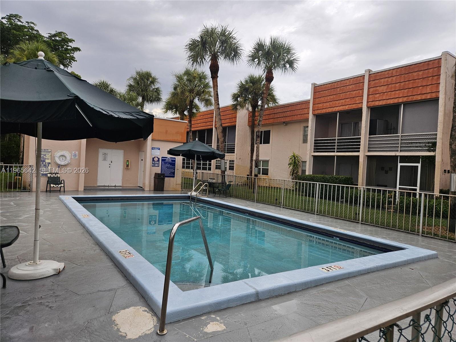 7610 Stirling Road, Unit 102C Davie, FL 33024 - Photo 10 of 11 a view of swimming pool with outdoor seating