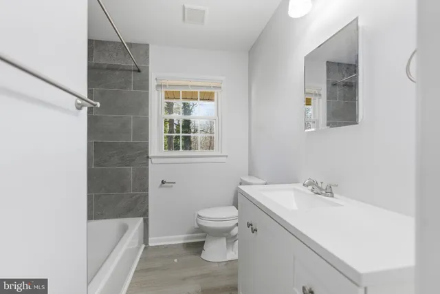 a white toilet sitting next to a bathroom sink