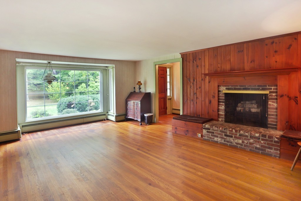7 Stagecoach Road Topsfield, MA 01983 - Photo 11 of 26 a view of empty room with wooden floor and fireplace