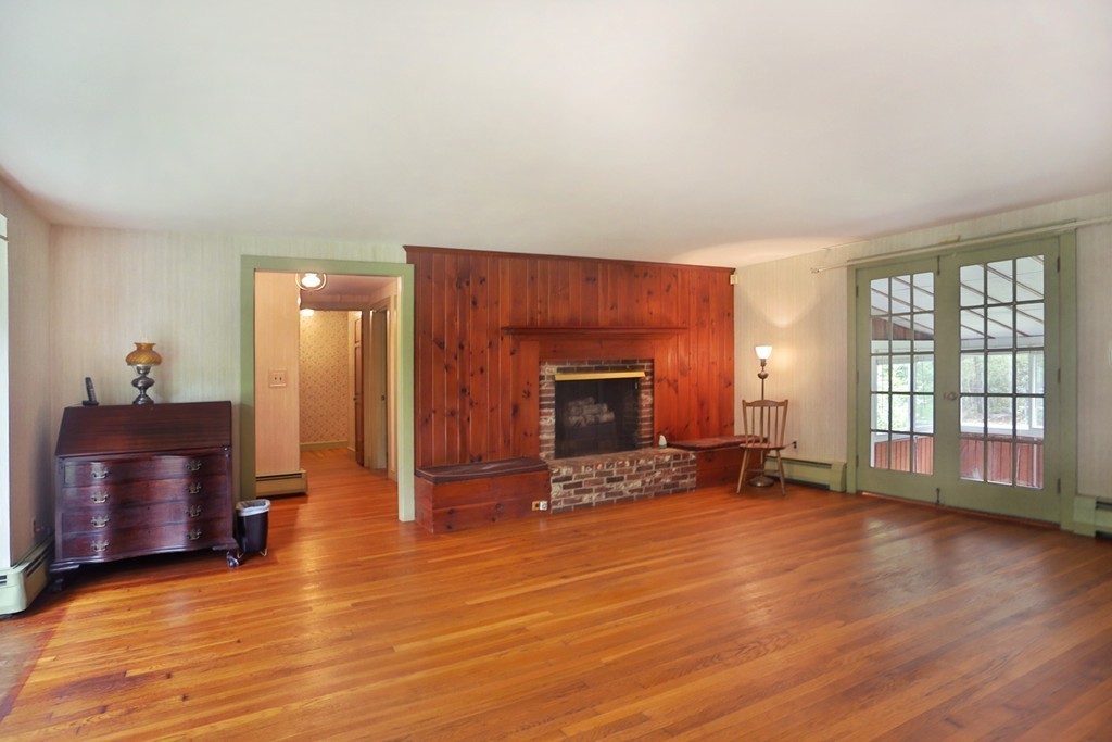 7 Stagecoach Road Topsfield, MA 01983 - Photo 10 of 26 wooden floor fireplace and windows in an empty room