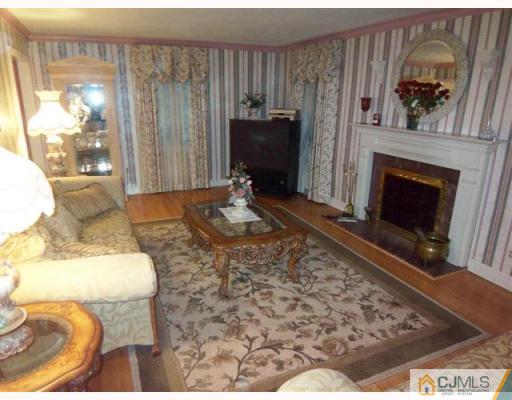 80 Stafford Road Colonia, NJ 07067 - Photo 2 of 10 a living room with furniture and a fireplace