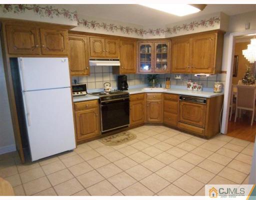 80 Stafford Road Colonia, NJ 07067 - Photo 4 of 10 a kitchen with stainless steel appliances granite countertop a stove a sink and a refrigerator
