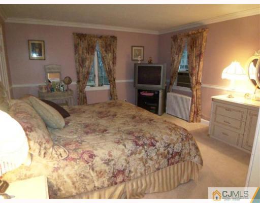 80 Stafford Road Colonia, NJ 07067 - Photo 7 of 10 a bedroom with a bed flat screen tv and a large window