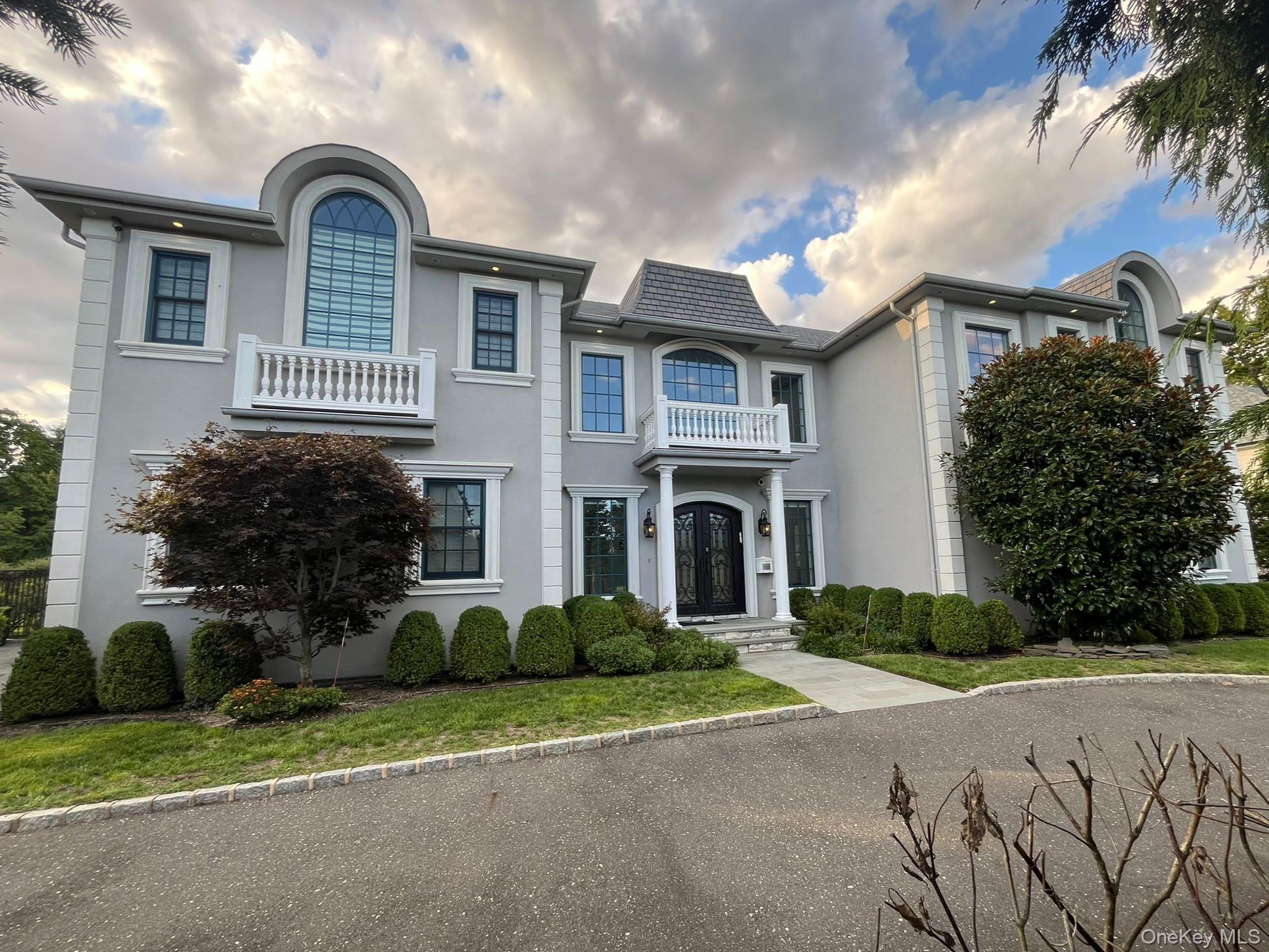 a front view of a house with a garden