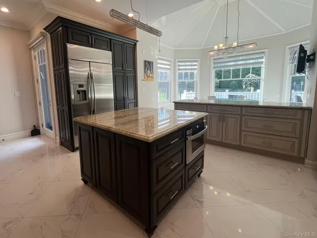 a kitchen with a stove a sink and a refrigerator
