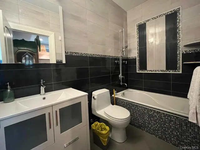 a bathroom with a toilet a sink and bathtub