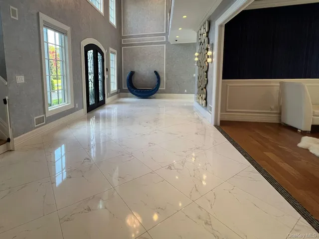 a view of a livingroom with furniture and an empty room
