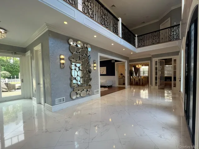 a view of a hallway with dining area and chandelier
