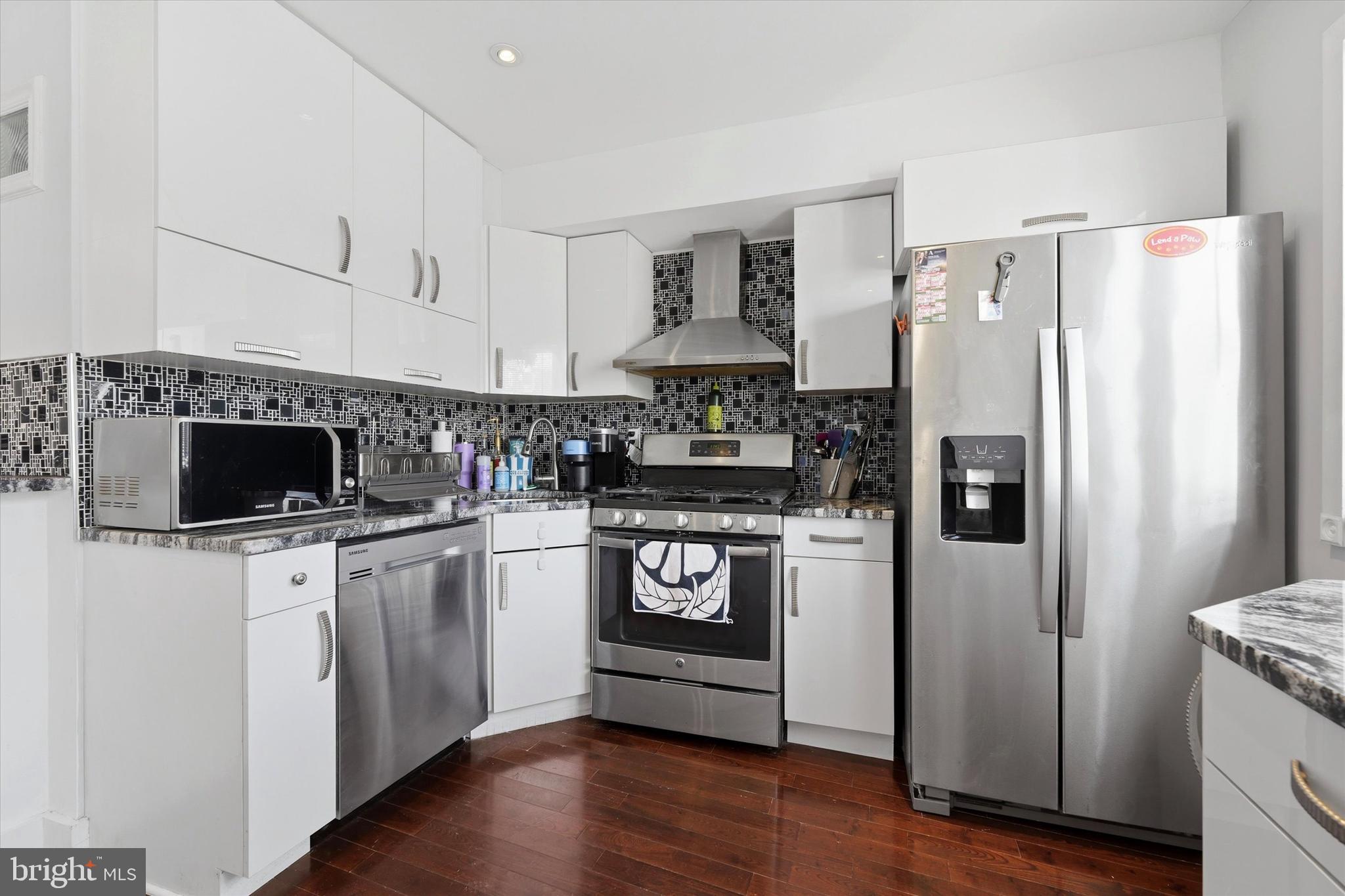 2152 East Letterly Street Philadelphia, PA 19125 - Photo 11 of 24 a kitchen with stainless steel appliances a refrigerator stove and sink