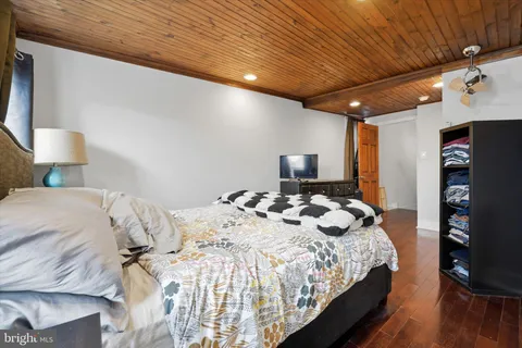 a bedroom with a bed and a tv