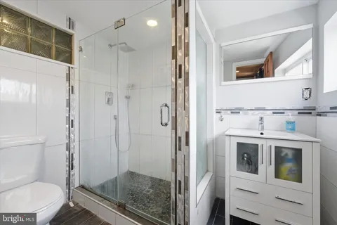 a bathroom with a shower a toilet and a sink