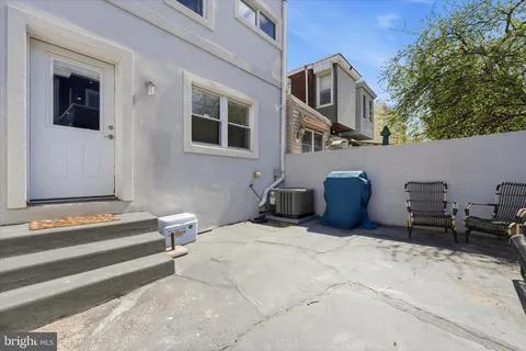 a backyard of a house with table and chairs