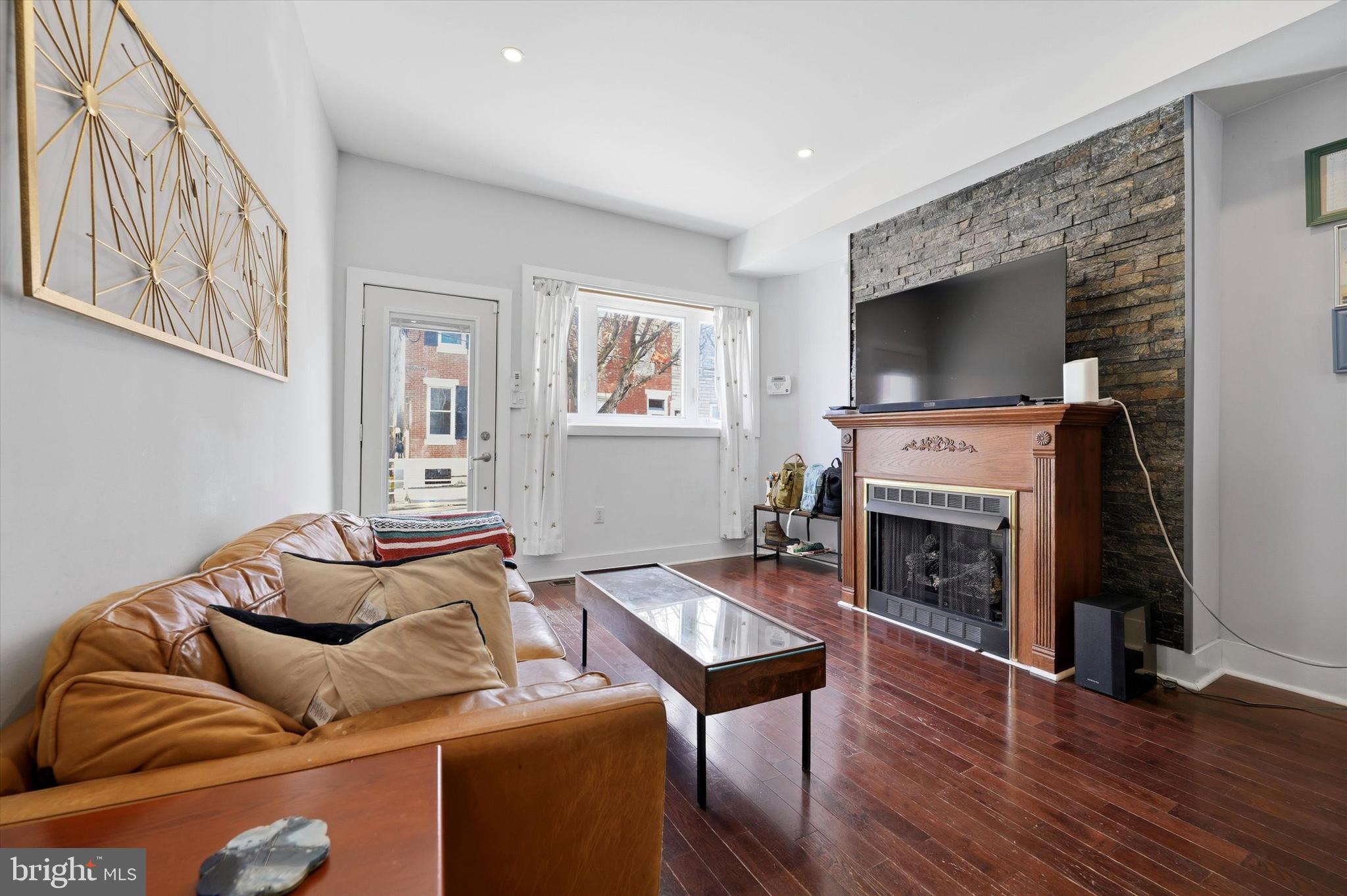 2152 East Letterly Street Philadelphia, PA 19125 - Photo 3 of 24 a living room with furniture a flat screen tv and a fireplace