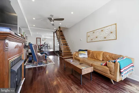 a living room with couch and wooden floor